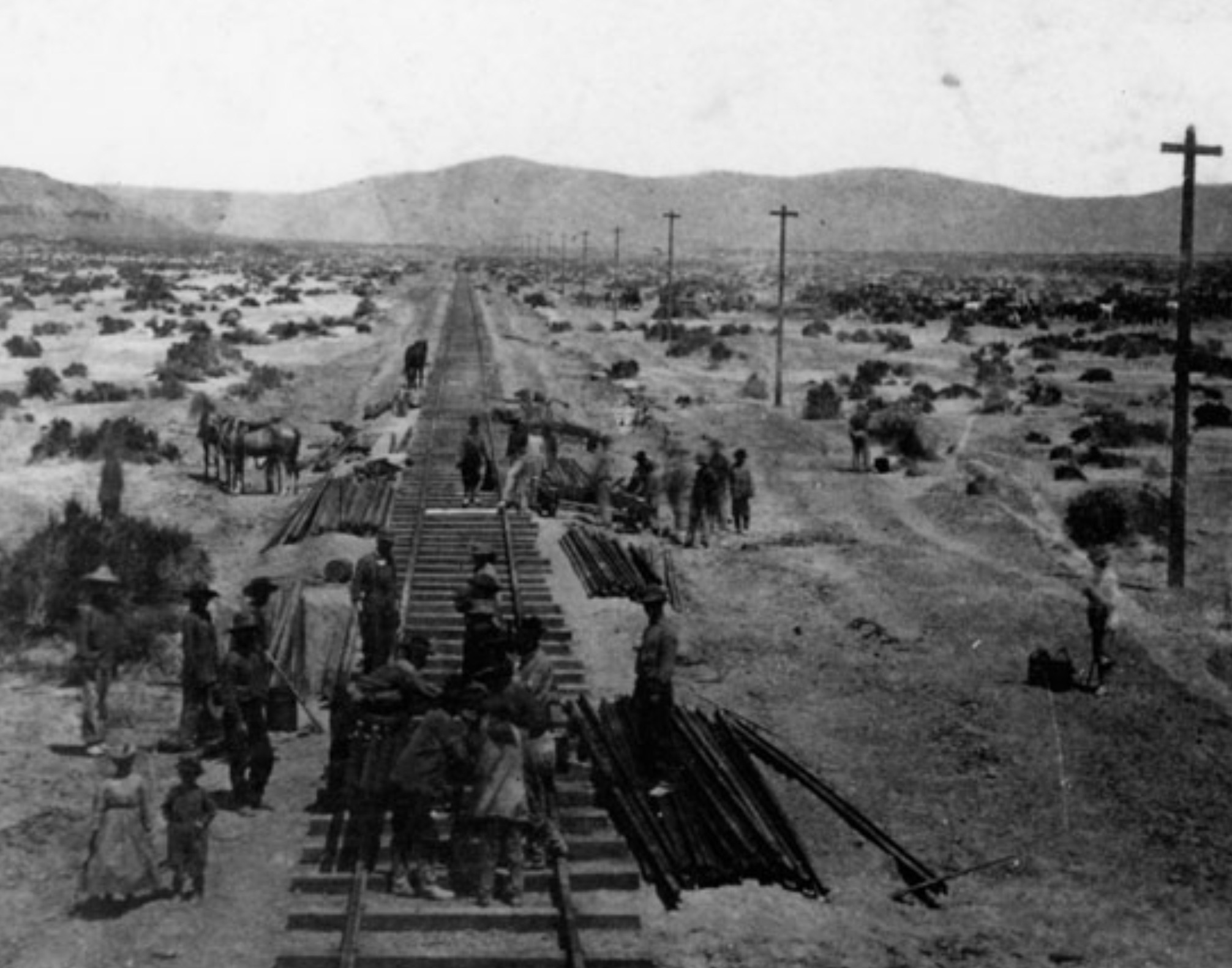 Central Pacific workers laying rail at the end of track, Humboldt Plains, Nevada. 